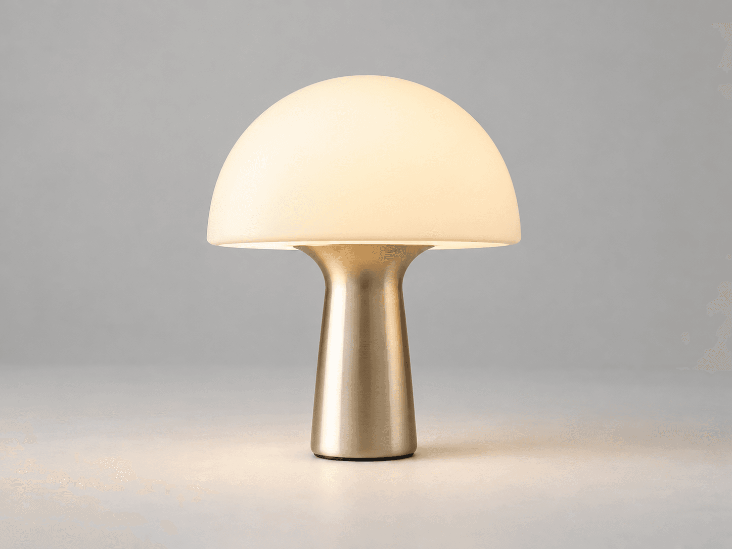 Cream mushroom lamp on a softly lit neutral studio background
