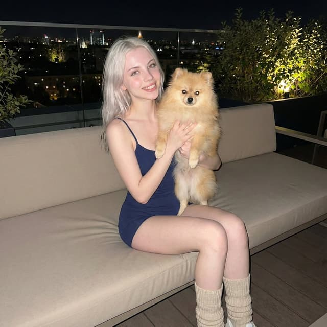 Social Media Post - Photorealistic Portrait of Woman Holding a Pomeranian (iPhone Style) — output
