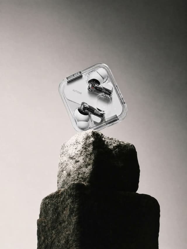 E-commerce Main Image - Transparent Earbuds on Stone Pedestal — output