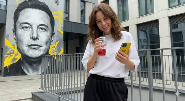 Urban Lifestyle Portrait with Elon Musk Mural Background — output