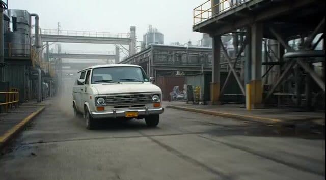 Badass tracking shot of a van speeding through an industrial complex — cover