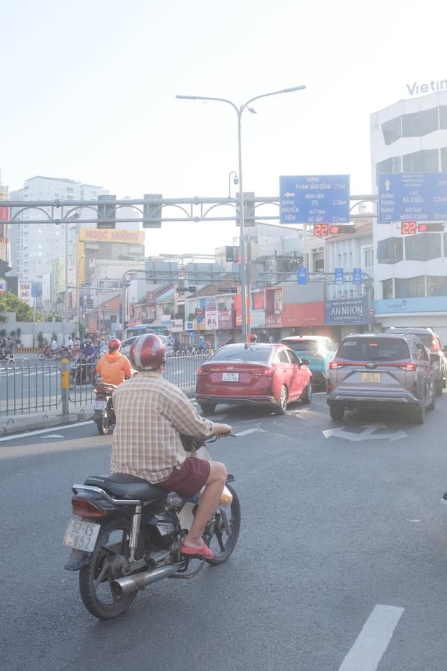 Edit city photo into rainy scene with Vietnamese bikers — output