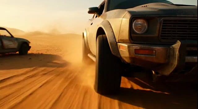 Tracking shot of armored muscle car in desert — cover