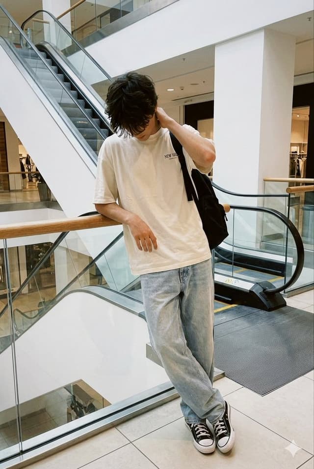 Profile / Avatar - Realistic candid smartphone photo of a subject standing by an escalator in a mall — output