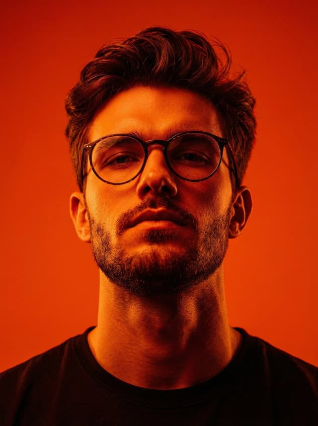 Dynamic Low-Angle Editorial Portrait with Orange-Red Contrast — output